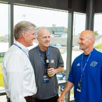 Randy Damstra talking with two guests at the Jamie Hosford Football Center dedication.
